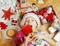 Little cute kid in santas red hat with handmade gifts, toys vintage Royalty Free Stock Photo