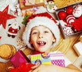 Little cute kid in santas red hat with handmade gifts, toys vintage wooden, warm winter Royalty Free Stock Photo