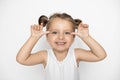 Little cute laughing Caucasian 3 years old girl makes grimace with her hands and face. Crazy funny little girl grimacing Royalty Free Stock Photo