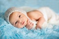 Little cute newborn baby boy, sleeping wrapped in white wrap Royalty Free Stock Photo