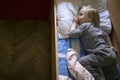 Little cute pensive blonde boy lying in bed Royalty Free Stock Photo