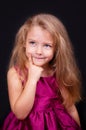 Little cute pensive girl in a bright pink dress Royalty Free Stock Photo