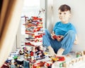 Little cute preschooler boy playing lego toys at home happy smiling, lifestyle children concept Royalty Free Stock Photo