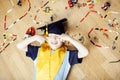 Little cute preschooler boy among toys lego at home in graduate hat smiling posing emotional, lifestyle people concept Royalty Free Stock Photo