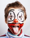 little cute real boy with facepaint like clown, pantomimic expre