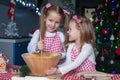 Little cute sisters bake gingerbread cookies for Royalty Free Stock Photo