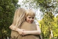 Little Cute Smiling Caucasian 7 Yo Boy Sits In Mother& x27;s Arms, Hugging Her Royalty Free Stock Photo