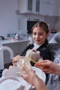 Little cute smiling girl is sitting in dental chair in clinic, office. Doctor is preparing for examination of child Royalty Free Stock Photo