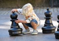 Little cute toddler boy playing outdoor chess Royalty Free Stock Photo