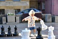 Little cute toddler boy playing outdoor chess Royalty Free Stock Photo