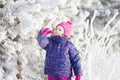 Little cute toddler girl outdoors on a sunny winter day. Royalty Free Stock Photo