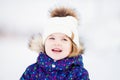 Little cute toddler girl outdoors on a sunny winter day Royalty Free Stock Photo