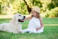 Little cute toddler girl playing with her big white shepherd dog. Selective focus Royalty Free Stock Photo