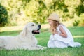 Little cute toddler girl playing with her big white shepherd dog. Selective focus Royalty Free Stock Photo