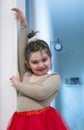 Little ballerina posing leaning against a wall Royalty Free Stock Photo