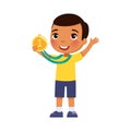 Little dark skin boy happy with a golden medal in his hand. Victory concept.