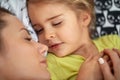 A little daughter in a carefree sleep with her Mam. Family, home, together