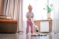 little daughter cleaning in the house, child dusting, Cute little helper girl washing floor with mop, happy family Royalty Free Stock Photo