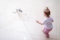 little daughter cleaning in the house, child dusting, Cute little helper girl washing floor with mop, happy family Royalty Free Stock Photo