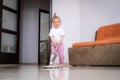 little daughter cleaning in the house, child dusting, Cute little helper girl washing floor with mop, happy family Royalty Free Stock Photo