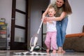 little daughter cleaning in the house, child dusting, Cute little helper girl washing floor with mop, happy family Royalty Free Stock Photo