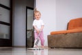 little daughter cleaning in the house, child dusting, Cute little helper girl washing floor with mop, happy family Royalty Free Stock Photo