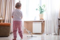 little daughter cleaning in the house, child dusting, Cute little helper girl washing floor with mop, happy family Royalty Free Stock Photo