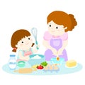 Little daughter cooking with her mother