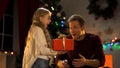 Little daughter giving Christmas present for surprised daddy, dream come true Royalty Free Stock Photo