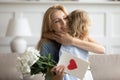 Little daughter greeting happy mom with Women Day holiday Royalty Free Stock Photo