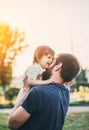 Little daughter in her father s arms, smiling and hugging dad in a summer park, father s day holiday concept Royalty Free Stock Photo