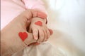 Little daughter holds dad by the finger. hearts for the day of p Royalty Free Stock Photo