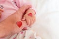 Little daughter holds dad by the finger. hearts for the day of p Royalty Free Stock Photo