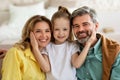 Little Daughter Hugging Parents Sitting Posing At Home Royalty Free Stock Photo