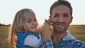 Little daughter plays with father s face and tortures him funny. Royalty Free Stock Photo