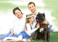 happy family with pet dog at picnic in a Sunny summer day. pregn Royalty Free Stock Photo