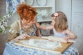 Little daughter touches a nose of her mother on a kitchen Royalty Free Stock Photo