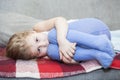 Little defenseless child huddled on the couch Royalty Free Stock Photo