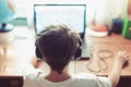 Little dependent gamer kid playing on laptop Royalty Free Stock Photo