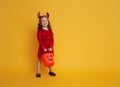 Little devil with a pumpkin Royalty Free Stock Photo