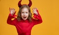 Little devil on yellow background Royalty Free Stock Photo