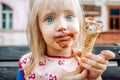 Little dirty faced child girl eating chocolate ice creame Royalty Free Stock Photo