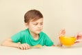 Little disaffected boy refuses to eat cereal