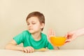 Little discontented boy refuses to eat porridge Royalty Free Stock Photo