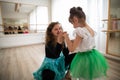 Little dissabled girl learning ballet with dance lecteur in ballet studio. Concept of integration and education of Royalty Free Stock Photo