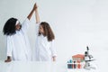 Little diversity African black and Caucasian children learning chemistry in school laboratory on white background Royalty Free Stock Photo