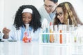 Little diversity Caucasian and African black kids learning chemistry in school laboratory Royalty Free Stock Photo