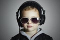 Little DJ. funny boy in sunglasses and headphones.child listening music in headphones. deejay