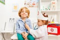 Little doctor examining boy with stethoscope Royalty Free Stock Photo