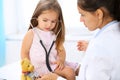 Little doctor examining a ntoy bear patient by stethoscope Royalty Free Stock Photo